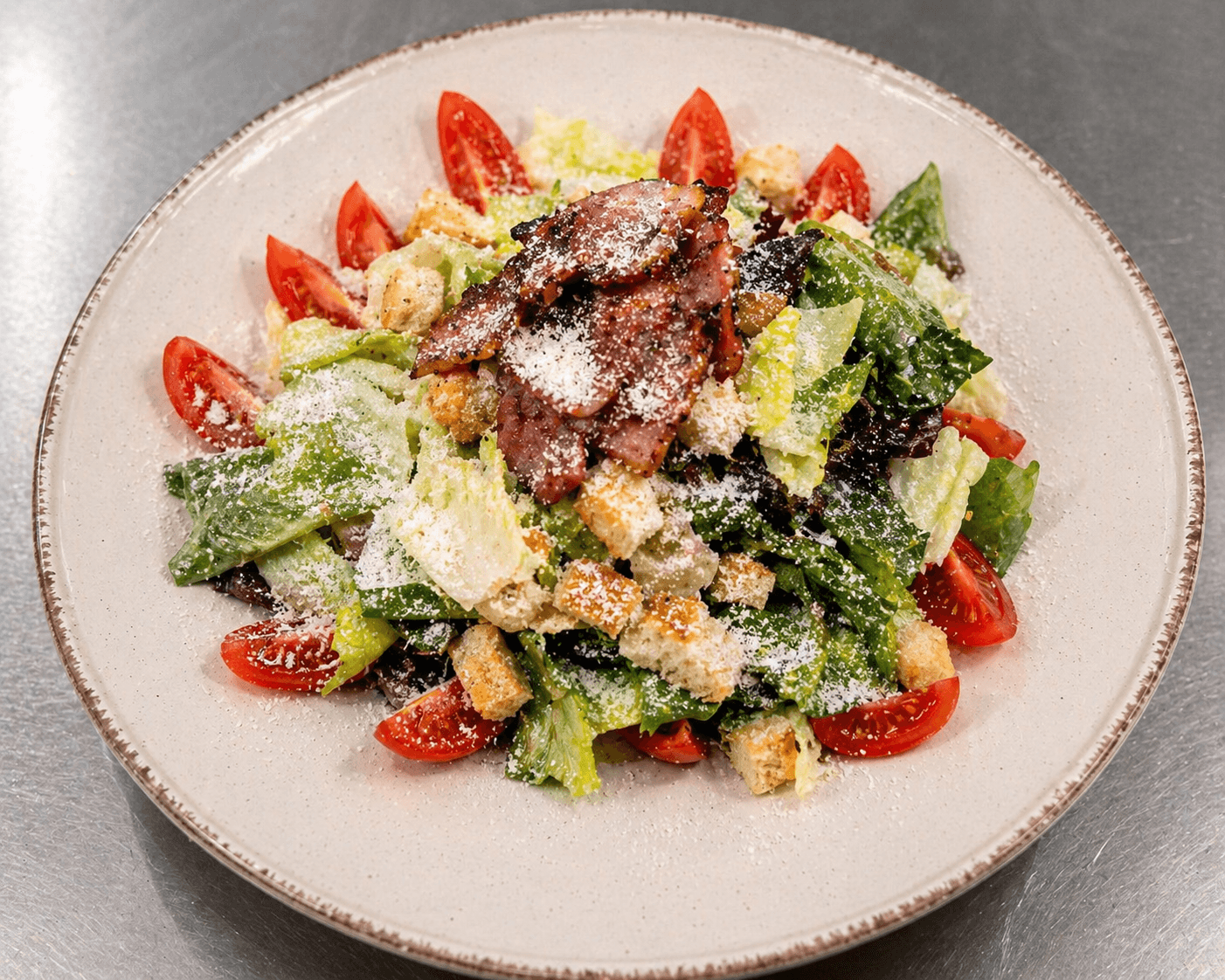 Orama signature salad with bacon, croutons, parmesan and cherry tomatoes